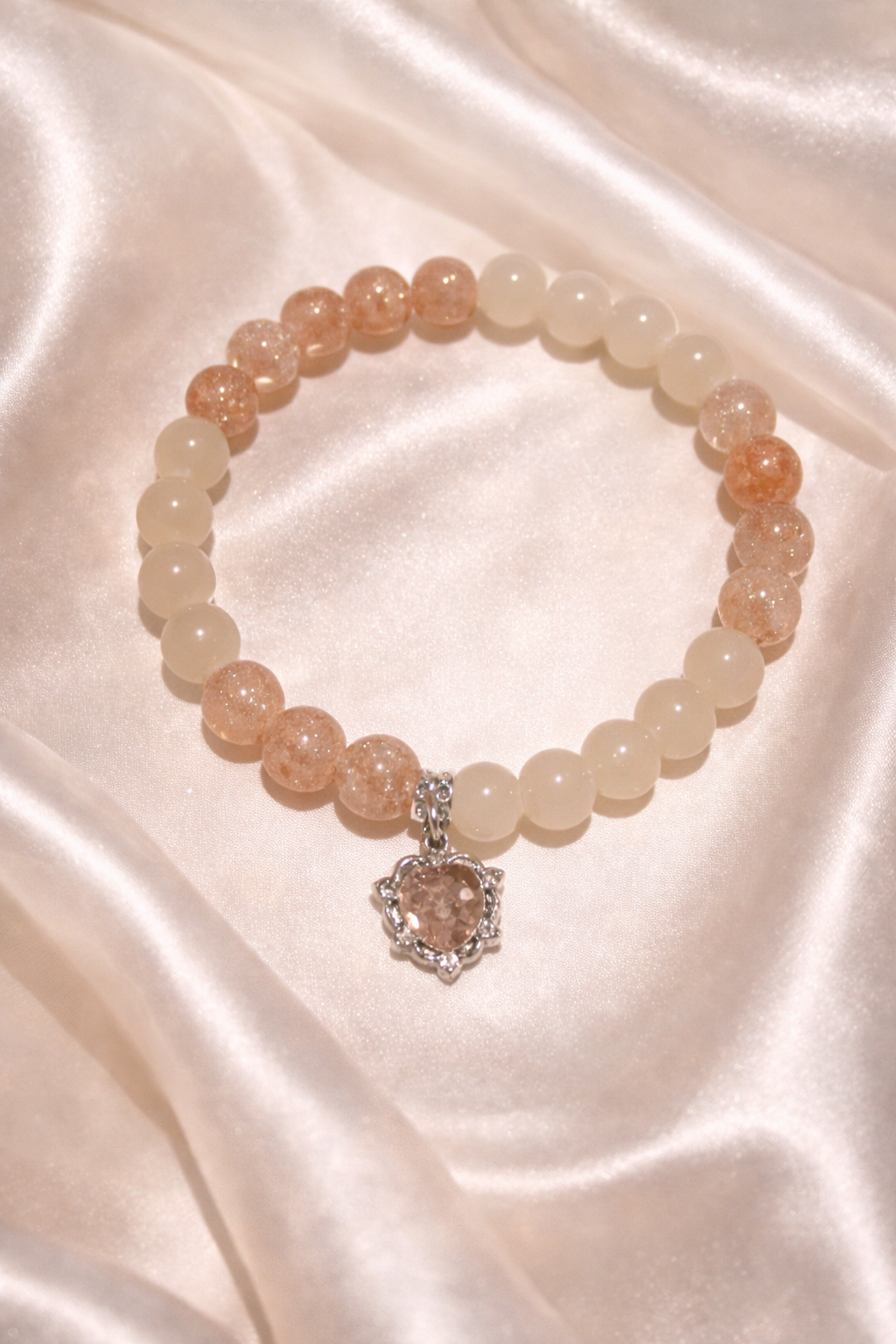 Peach and white glass bead bracelet with orange gem heart charm