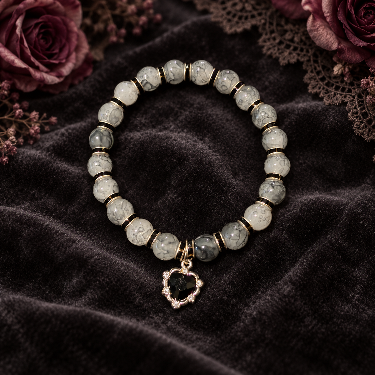 Two tone black glass bead bracelet with black spacers and black heart gem charm