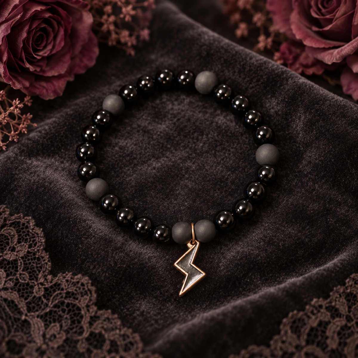 Black handcrafted glass bead bracket with a black lightning style charm
