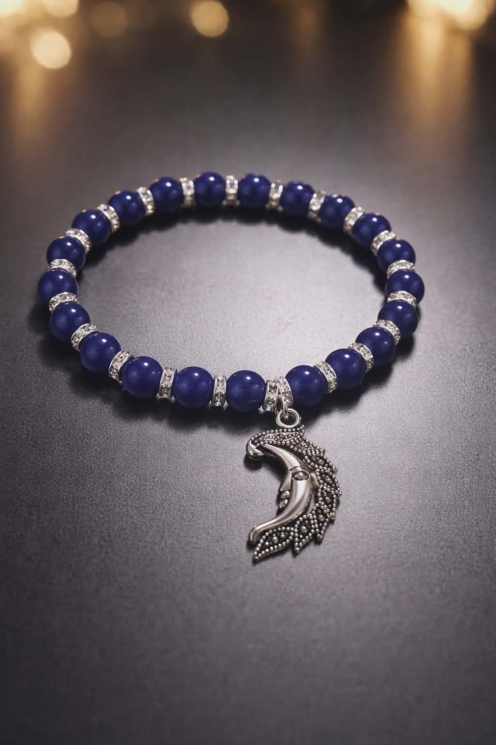 Dark Blue beads with silver spacers and a face in the moon charm handcrafted glass bead bracelet