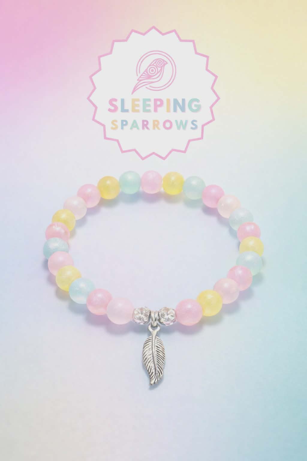 Pinky pale handcrafted glass bead bracelet random coloured beads with a feather charm