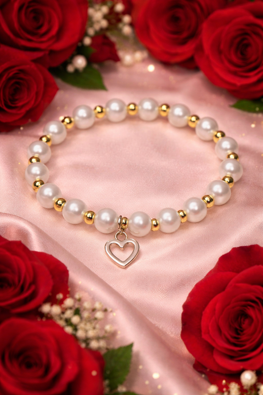 White glass bead bracelet with gold spacers and a white heart charm