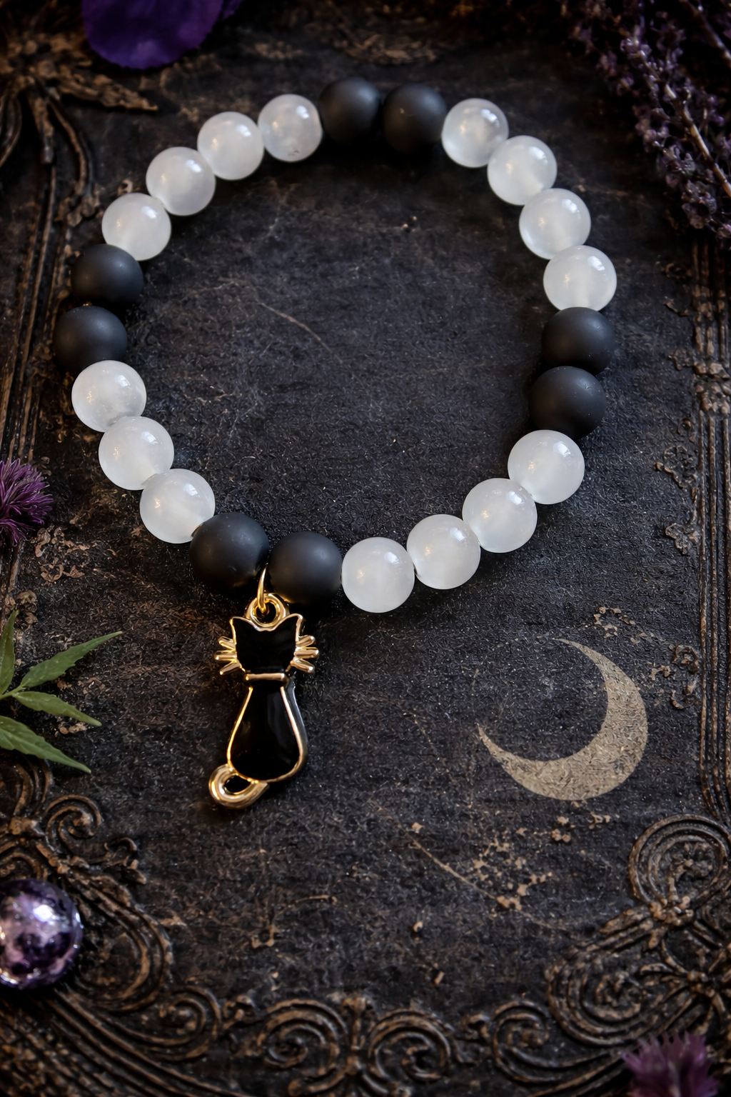 Black and white beads with a black charm handcrafted glass bead bracelet