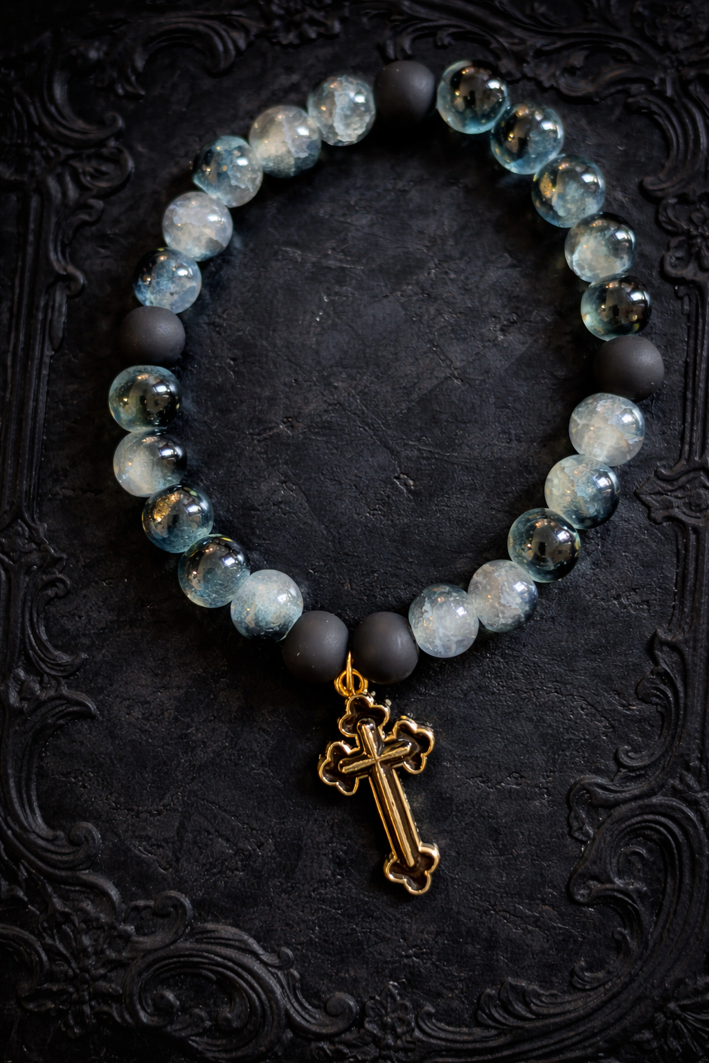 Black two tone beads with a black cross charm handcrafted glass bead bracelet
