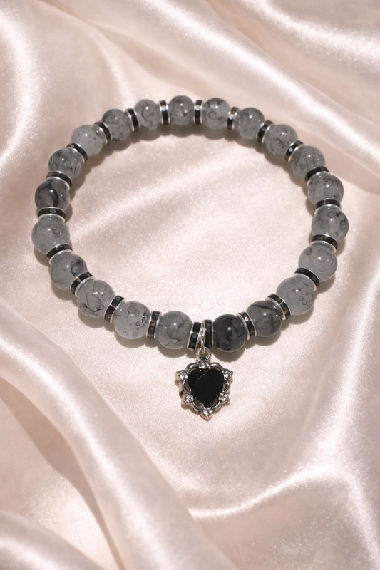Two tone black glass bead bracelet with black spacers and black heart gem charm