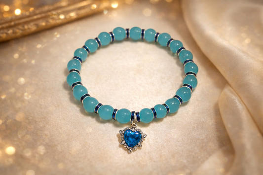 Light blue glass bead bracelet with dark blue spacers and a blue gem charm