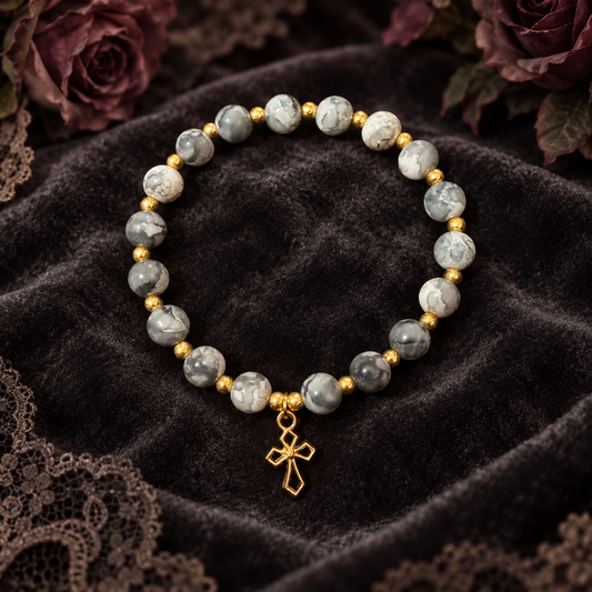 Black and white handcrafted glass bead bracelet with a gold cross charm