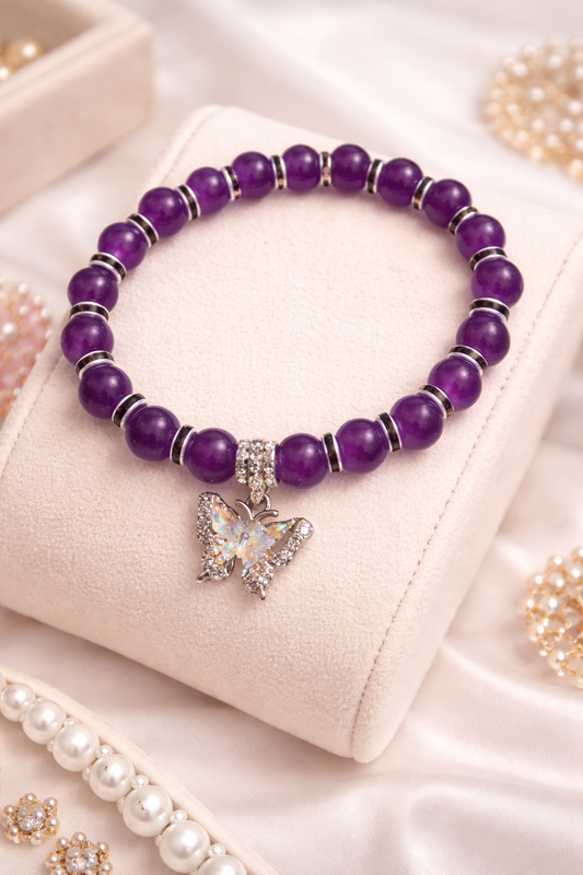Purple glass beads with black spacers with a butterfly charm handcrafted glass bead bracelet