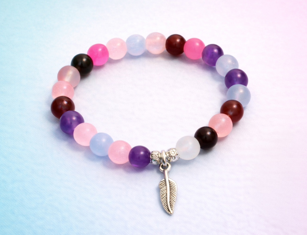 Deep handcrafted glass bead bracelet random coloured beads with a feather charm